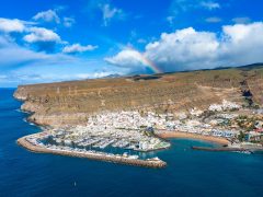 Aerial,View,Of,Puerto,De,Mogán,With,Rainbow,Over,The